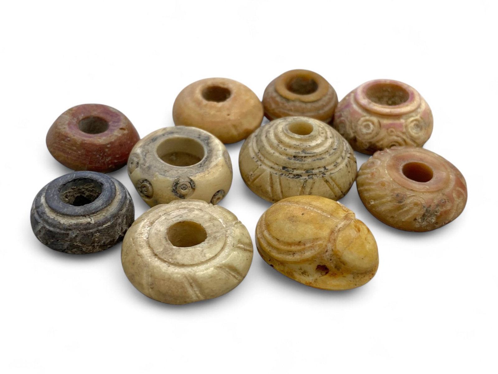 Ancient Coptic Egyptian Bone Spindle Whorls and Scarab Amulet, Spiral and Floral Motifs, 20g: This collection of ten miniature bone artifacts represents the everyday elegance and spiritual symbolism of ancient Coptic Egypt, dating to the Late Roman or early Byzantine periods. Each piece, delic