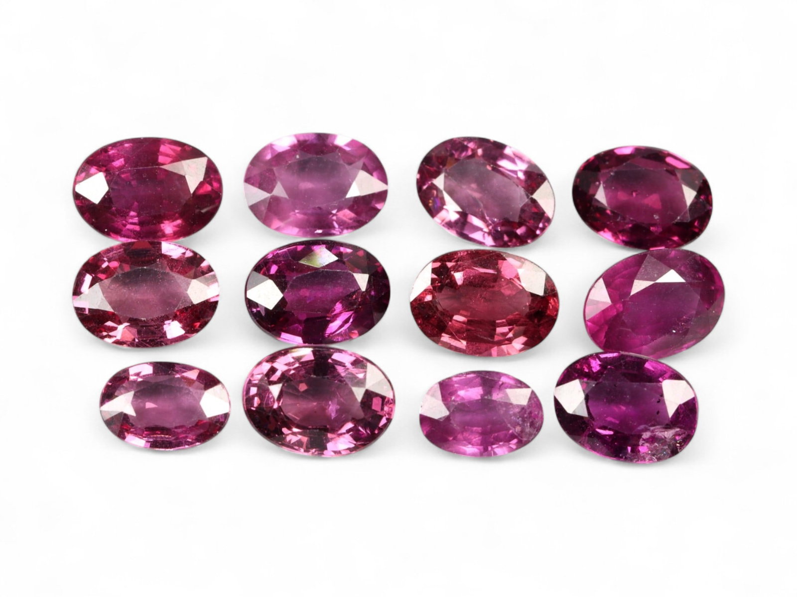 10.93 Carats Vibrant Raspberry Mahenge Garnet Parcel - Natural Tanzanian Stones: This striking parcel of oval-cut Mahenge garnets radiates with saturated raspberry, fuchsia, and plum tones, offering the unmistakable vibrancy that has made this variety a collector's favorite. Each 