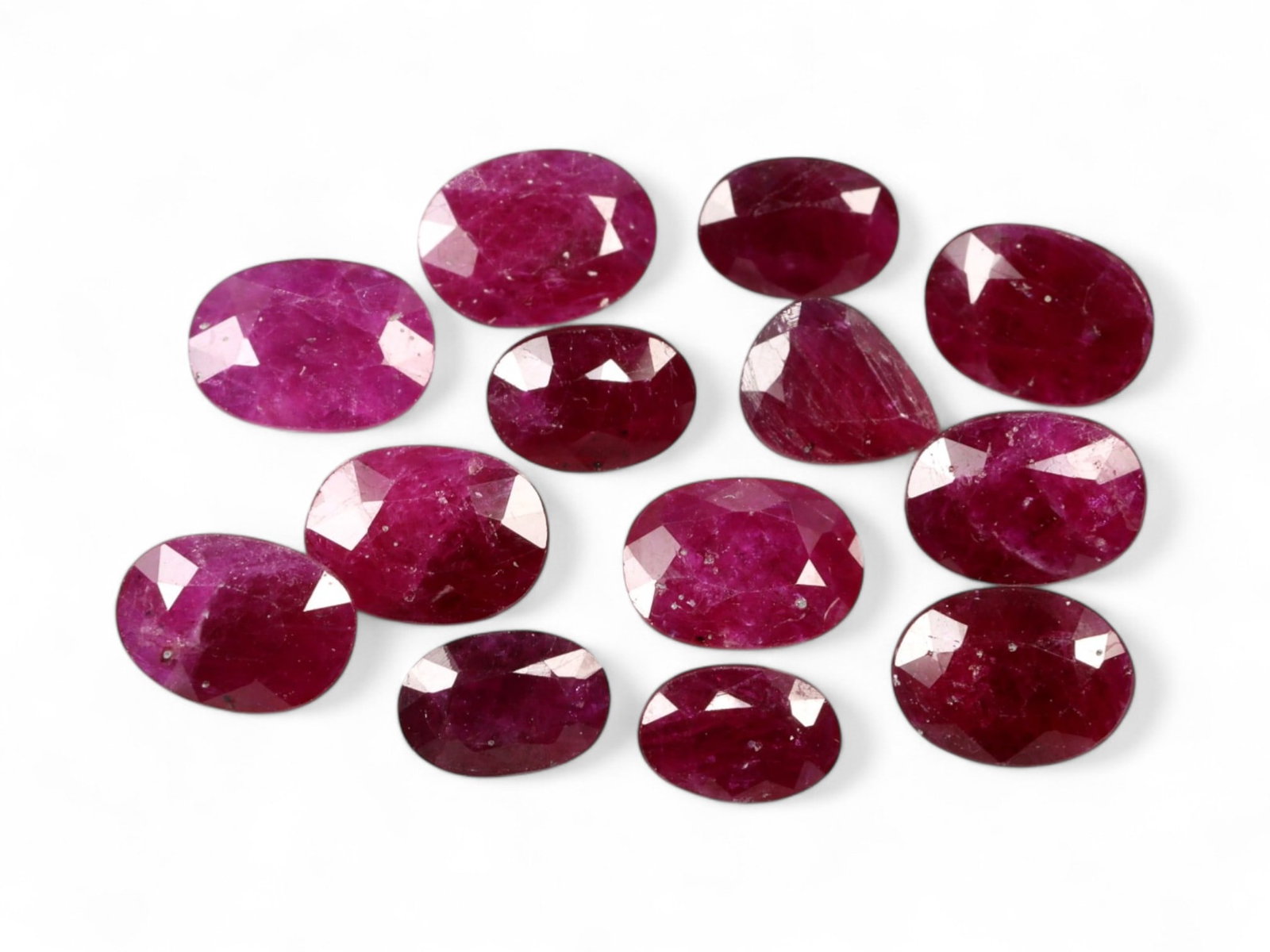 10.55 Carats Deep Crimson Red Ruby Parcel - Natural Mozambique Stones: This parcel of faceted rubies glows with a regal crimson red, enhanced by flashes of magenta and wine under light. Each oval-cut stone reveals a rich body color, ranging from classic ruby red to sligh