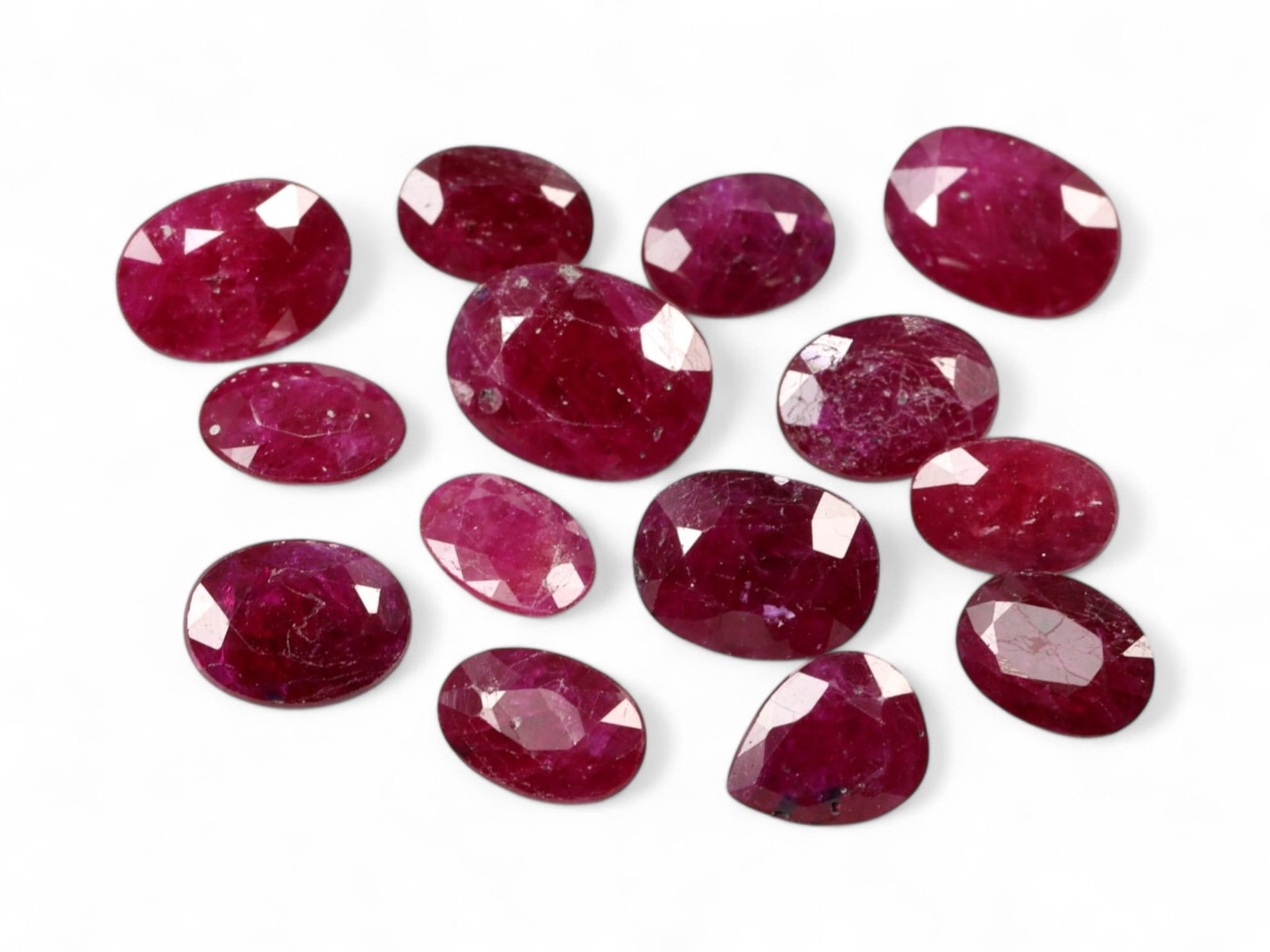 10.78 Carats Deep Crimson Red Ruby Parcel - Natural Mozambique Stones: This parcel of faceted rubies glows with a regal crimson red, enhanced by flashes of magenta and wine under light. Each oval-cut stone reveals a rich body color, ranging from classic ruby red to sligh