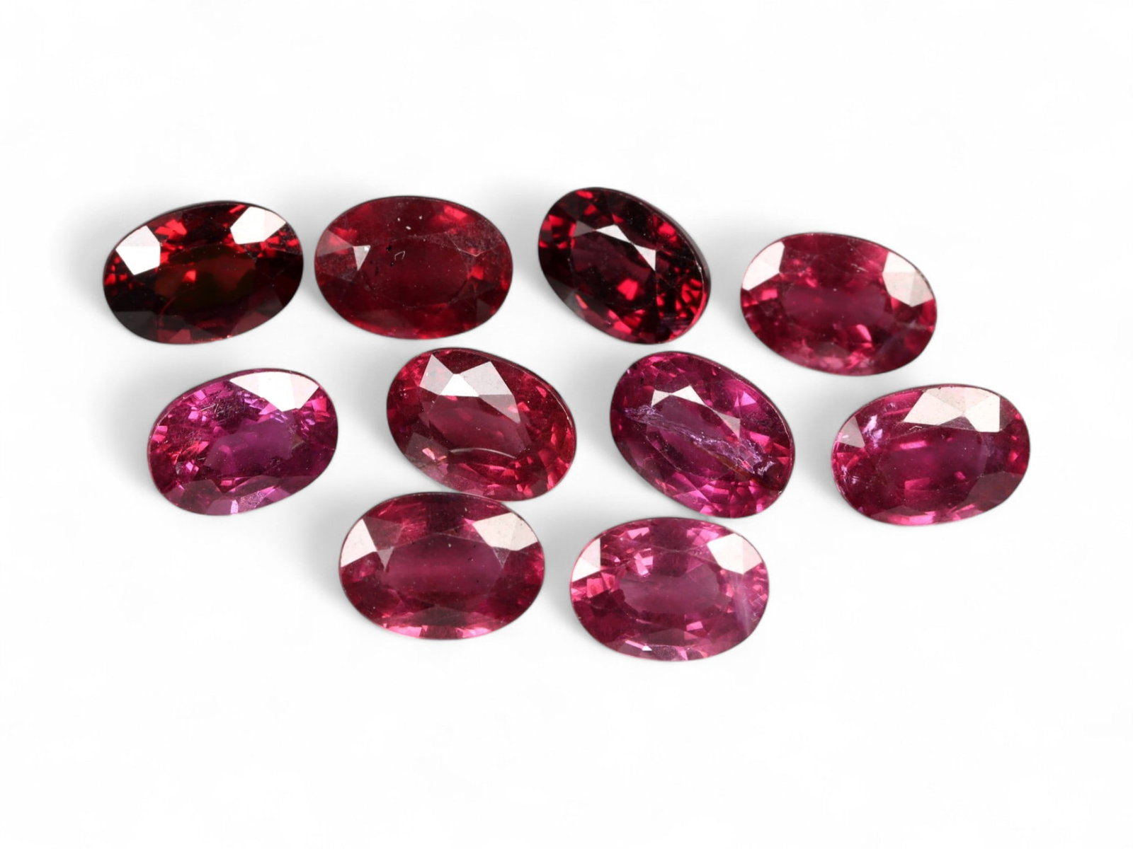 11.91 Carats Vibrant Raspberry Mahenge Garnet Parcel - Natural Tanzanian Stones: This striking parcel of oval-cut Mahenge garnets radiates with saturated raspberry, fuchsia, and plum tones, offering the unmistakable vibrancy that has made this variety a collector's favorite. Each 
