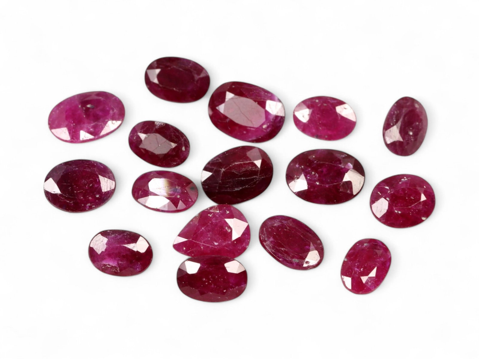 10.38 Carats Deep Crimson Red Ruby Parcel - Natural Mozambique Stones: This parcel of faceted rubies glows with a regal crimson red, enhanced by flashes of magenta and wine under light. Each oval-cut stone reveals a rich body color, ranging from classic ruby red to sligh