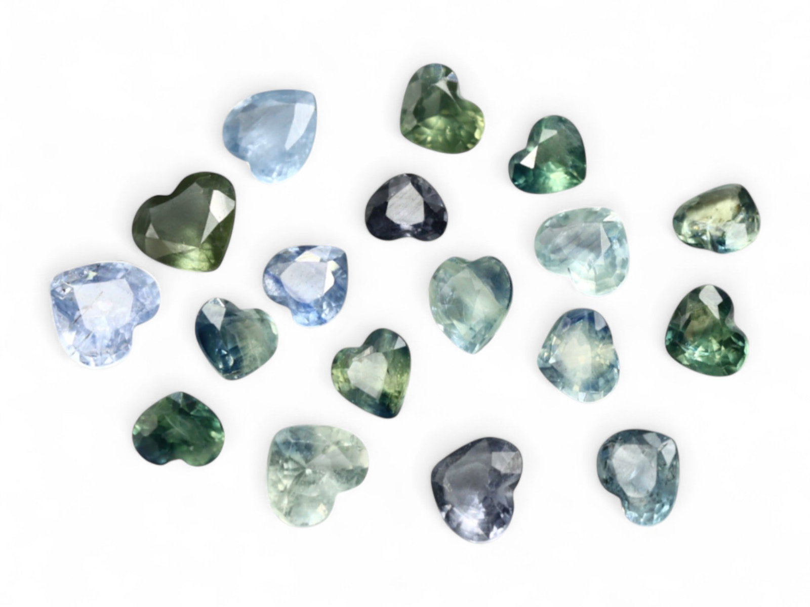 10.00 Carats Heart-Cut Sapphire Selection - Natural Sri Lankan Stones: A romantic offering of heart-cut sapphires, this 10.00 carat selection presents a spectrum of soft blues, silvery greens, and misty teals. Each gem has been meticulously shaped into a symmetrical hear