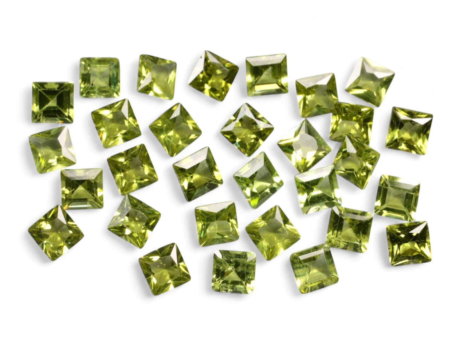 20.77 Carats Lime Green Peridot Square Lot - Natural Pakistani Stones: A vibrant collection of precision-cut peridot gems, this parcel radiates fresh lime and golden-chartreuse tones under the light. Each square-cut stone boasts sharp faceting and lively brilliance, with