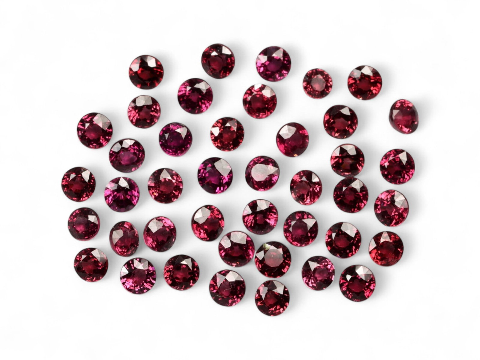 17.53 Carats Deep Raspberry Rhodolite Garnet Parcel - Natural Tanzanian Stones: This rich parcel of round-cut rhodolite garnets reveals a captivating range of deep raspberry, wine-red, and plum hues, shimmering with intense inner fire. The stones are finely calibrated and masterf