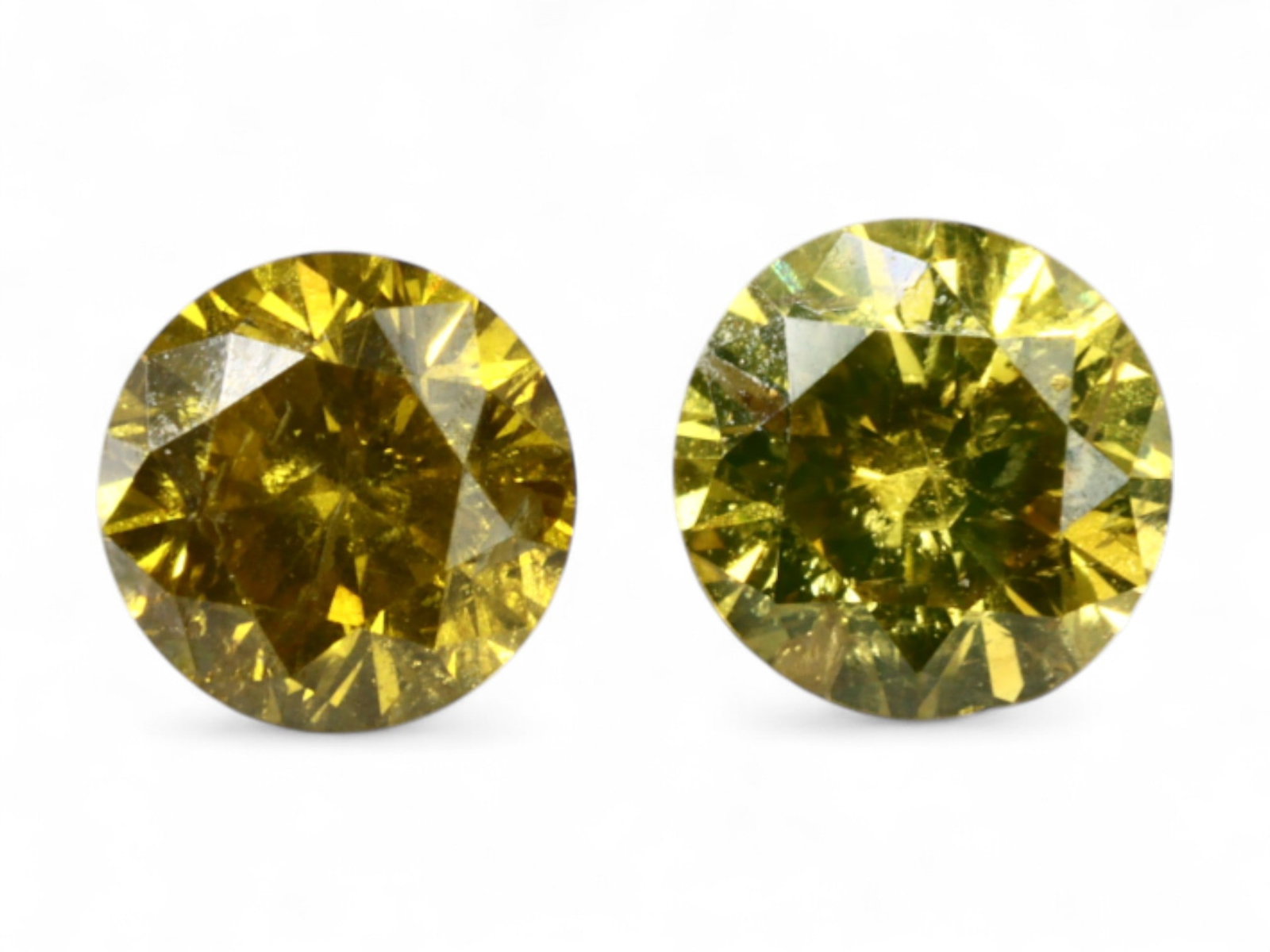0.26 Carats Golden Olive Fancy Diamond Pair - Natural Round Cuts, 3.1mm: This well-matched pair of 3.5 mm round-cut fancy diamonds glows with a rich golden olive hue, radiating depth and warmth through tightly arranged facets. Their luminous body color blends deep yellow w