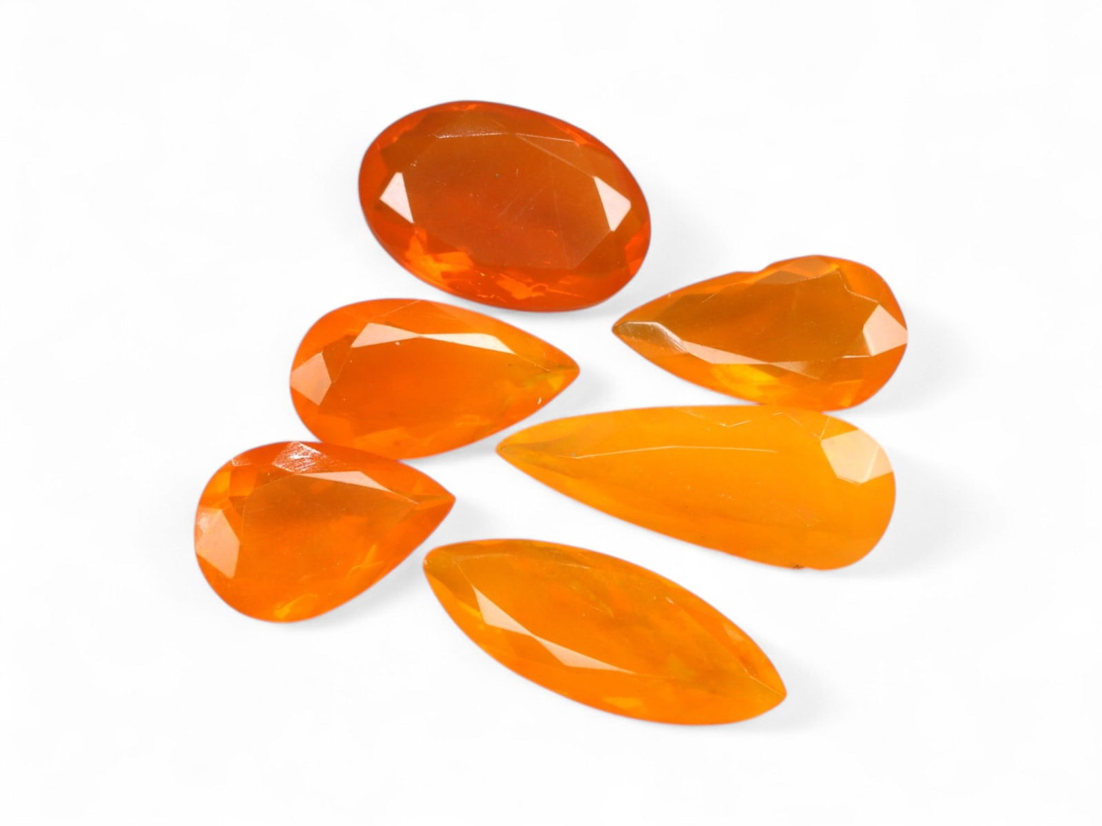 9.25 Carats Orange Welo Opal Pear Lot - Color-Enhanced Faceted Stones: Radiating with vivid tangerine and flame-orange hues, this dynamic parcel of faceted Welo opals offers a modern take on one of Ethiopia's most captivating gem varieties. Each stone is cut in elongated
