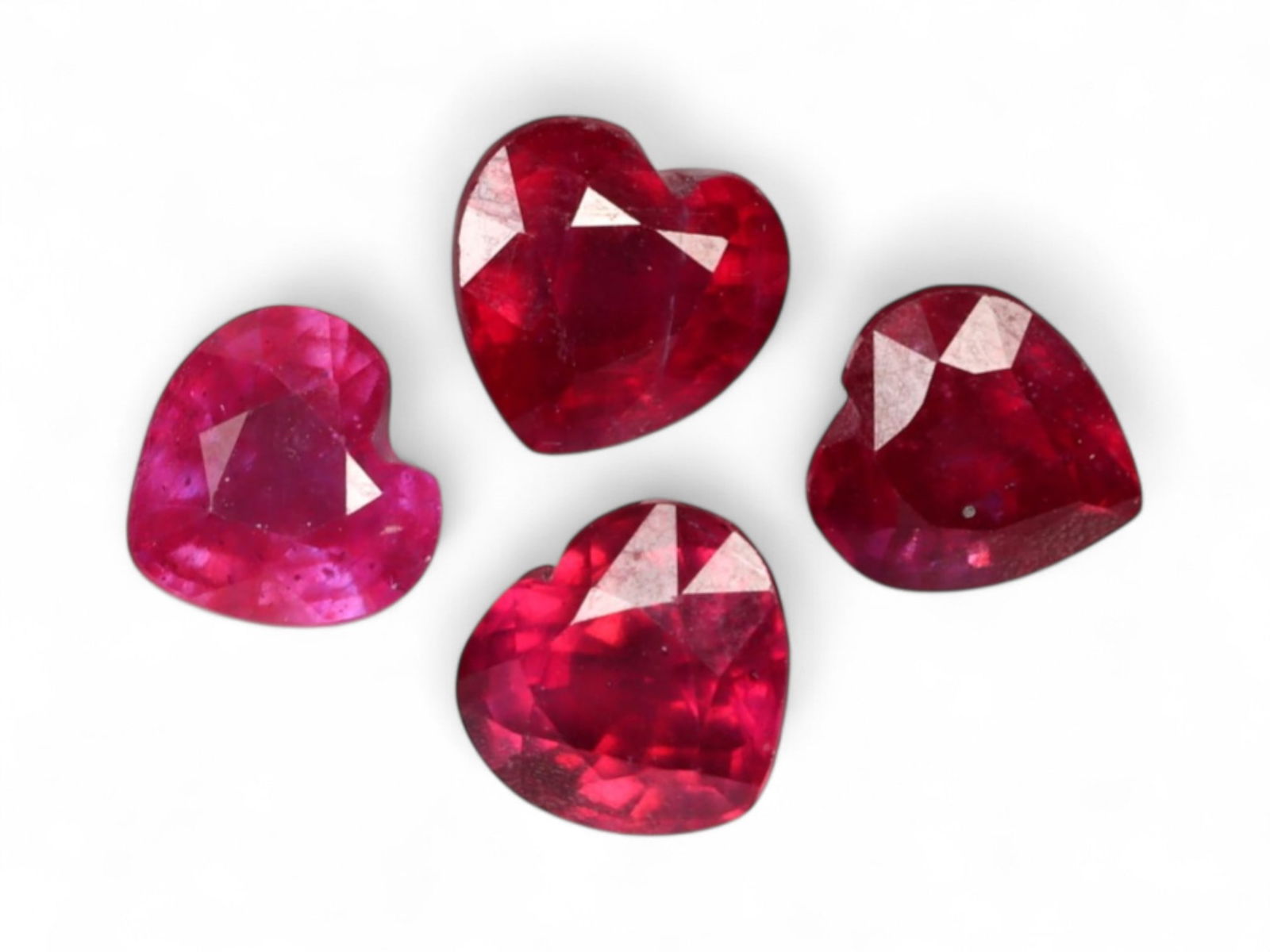 7.15 Carats Deep Red Ruby Heart Lot - Natural Burmese Stones: This striking quartet of heart-cut rubies radiates with an intense crimson hue, each stone exuding bold romanticism and vibrant inner fire. The color ranges from blood red to velvety wine tones, enhan