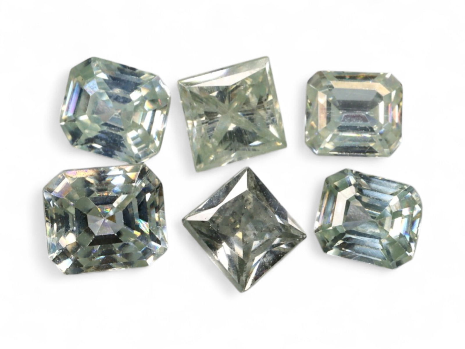 7.47 Carats Step-Cut Moissanite Fancy Shape Lot - Brilliant Pale Green Hues: This stylish parcel of moissanites features a mix of radiant, emerald, and princess cuts, each glowing with a subtle pale green body color and sharp architectural brilliance. The step faceting emphasi