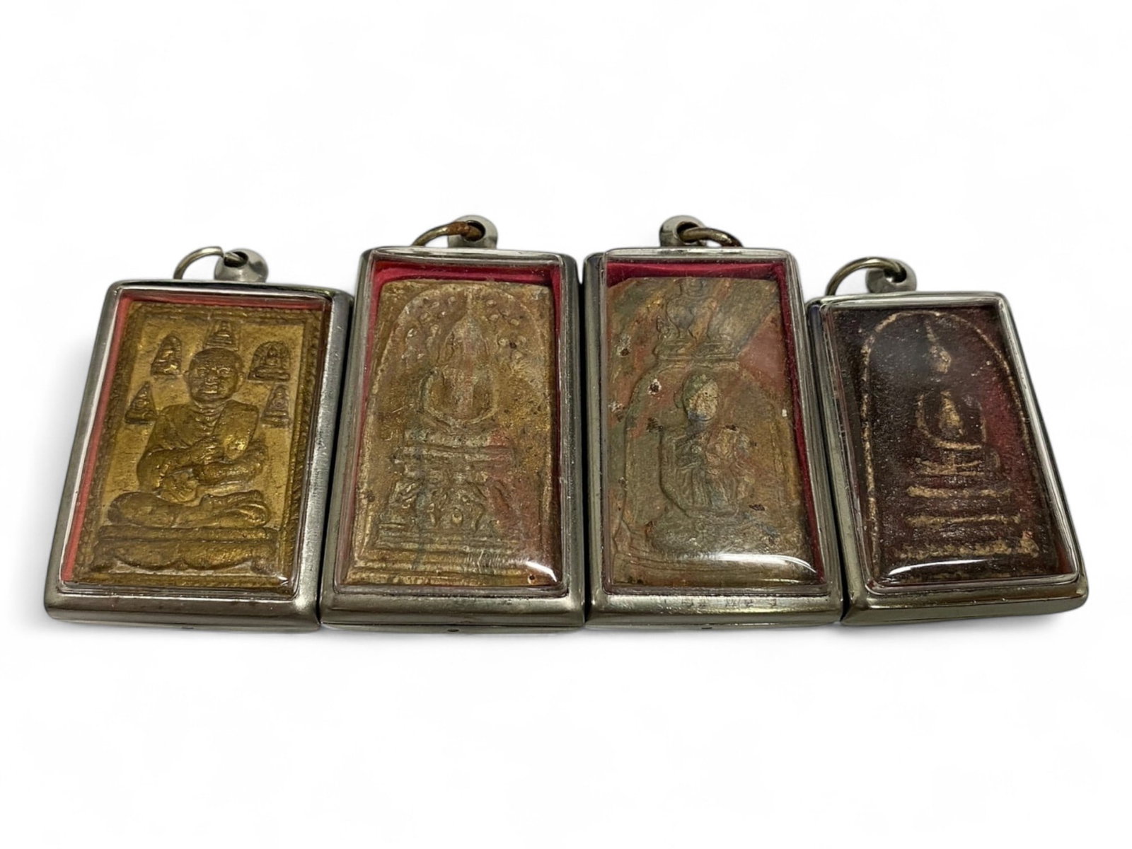 Antique Thai Gilded Clay Amulet Set of Enlightened Figures and Relics, c. 19th Century, 93g: This radiant set of four Thai amulets offers a beautifully aged glimpse into the sacred iconography of 19th-century Theravada Buddhism. Crafted in consecrated clay and measuring between 4.9 and 5.5 cm