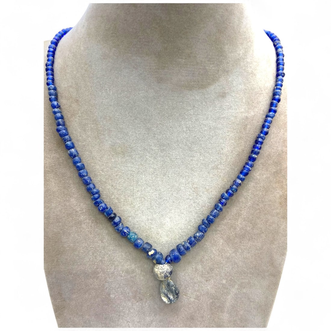 Ancient Roman Imperial Blue Glass Bead Strand Necklace, Unstrung Relic, c. 1st-3rd Century CE, 21g: This stunning strand of ancient Roman glass beads, rendered in a deep cobalt blue, exemplifies the elegance and technical mastery of Roman glasswork from the Imperial era. Dating to the 1st-3rd centur