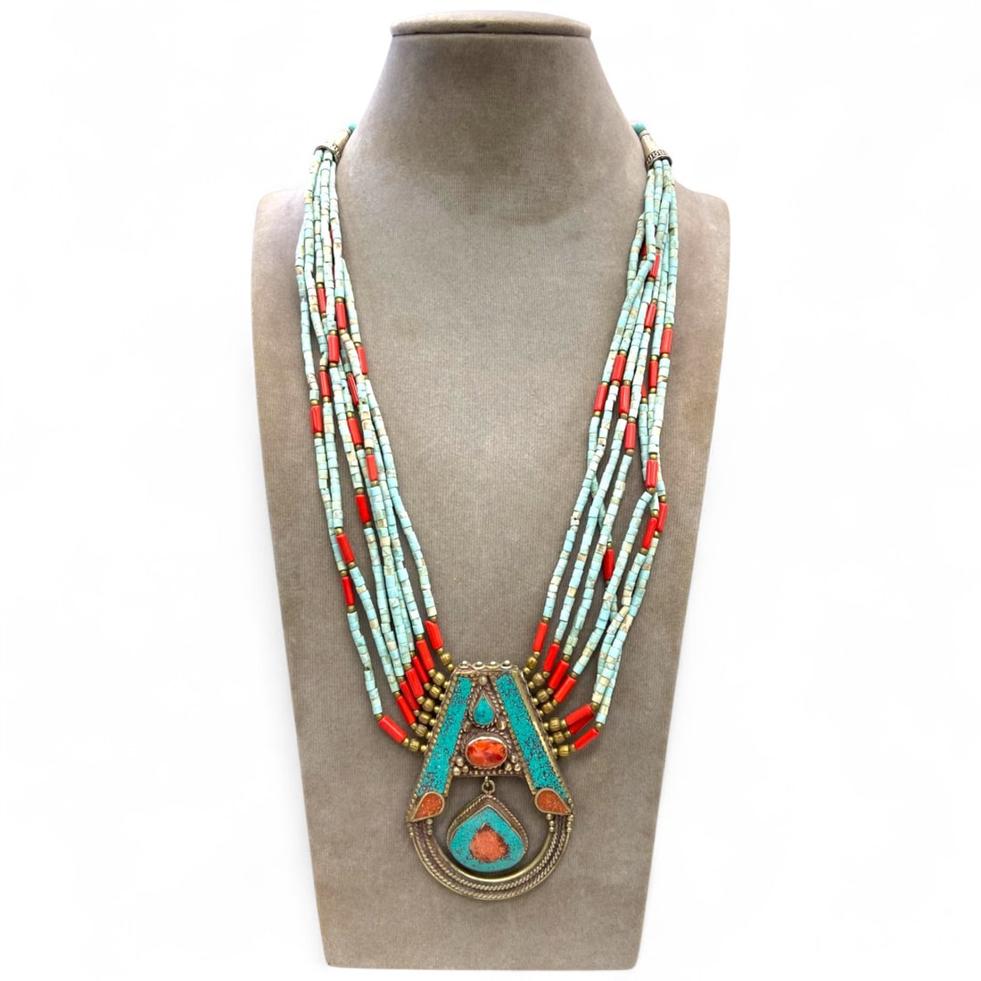 Tribal Himalayan Turquoise and Coral Multi-Strand Necklace with Ritual Pendant, 111g: This bold and richly symbolic tribal necklace hails from the Himalayan highlands, likely crafted in the 18th-19th century CE. Featuring vibrant strands of turquoise heishi beads interspersed with brig