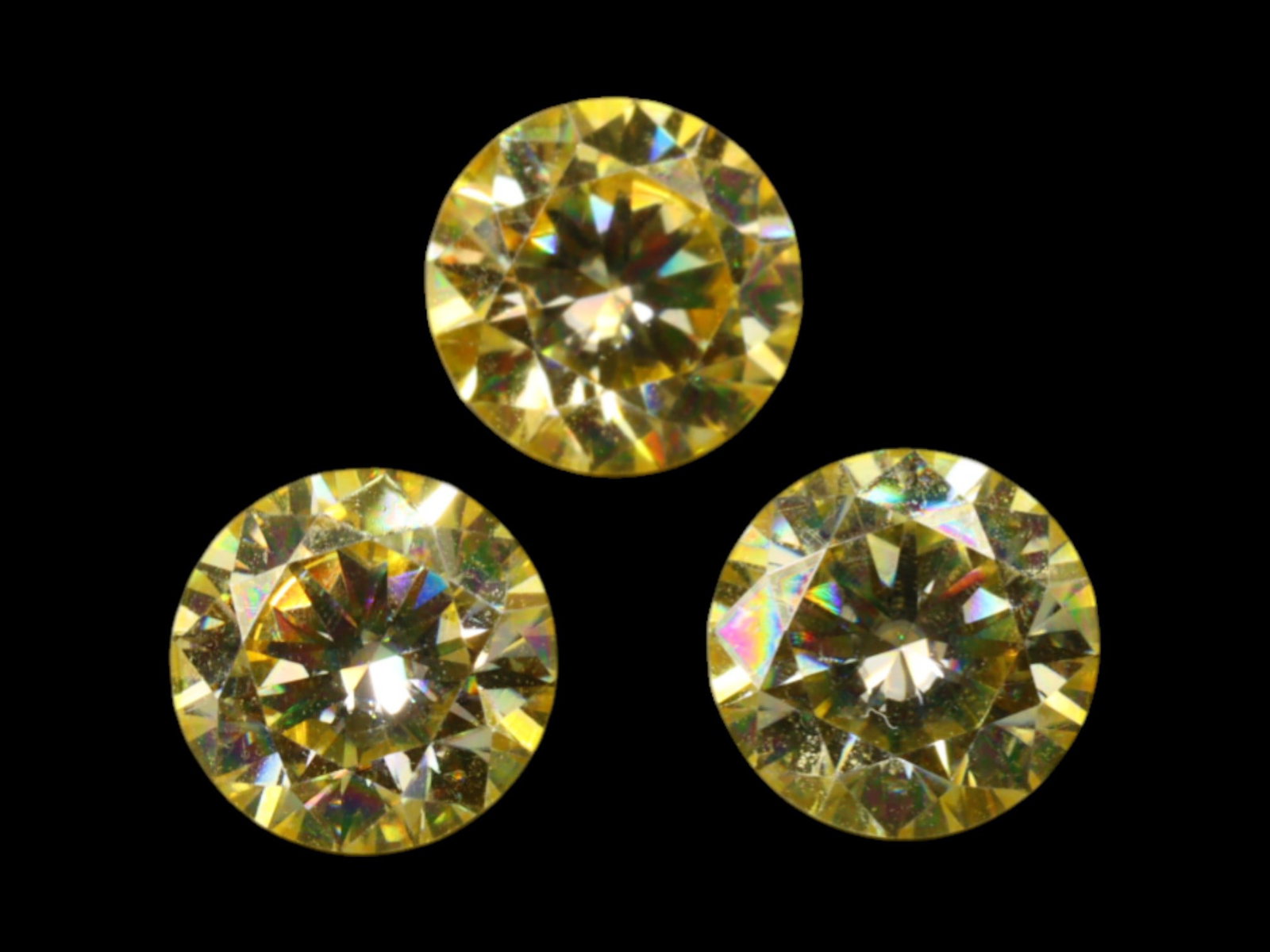 2.87 Carats Vivid Yellow Moissanite Trio - Precision Round Brilliant Cut: This radiant trio of round brilliant moissanites captures the eye with a burst of golden fire and unmistakable sparkle. Their vivid yellow tone is evenly distributed and richly saturated, delivering h