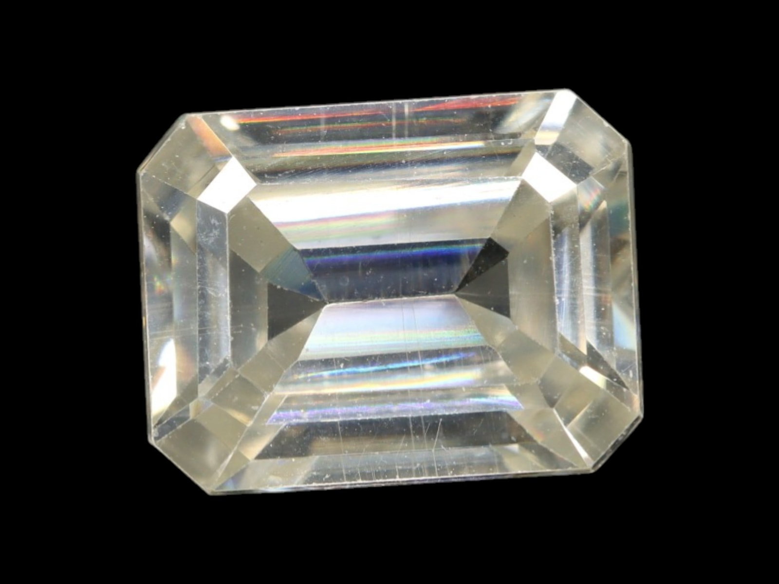 2.54 Carats Near-Colorless Moissanite Emerald Cut - Precision Step Faceting: This emerald-cut moissanite offers timeless elegance through clean step facets and sharp symmetry. Its near-colorless body displays brilliant clarity with subtle prismatic flashes under light, creatin