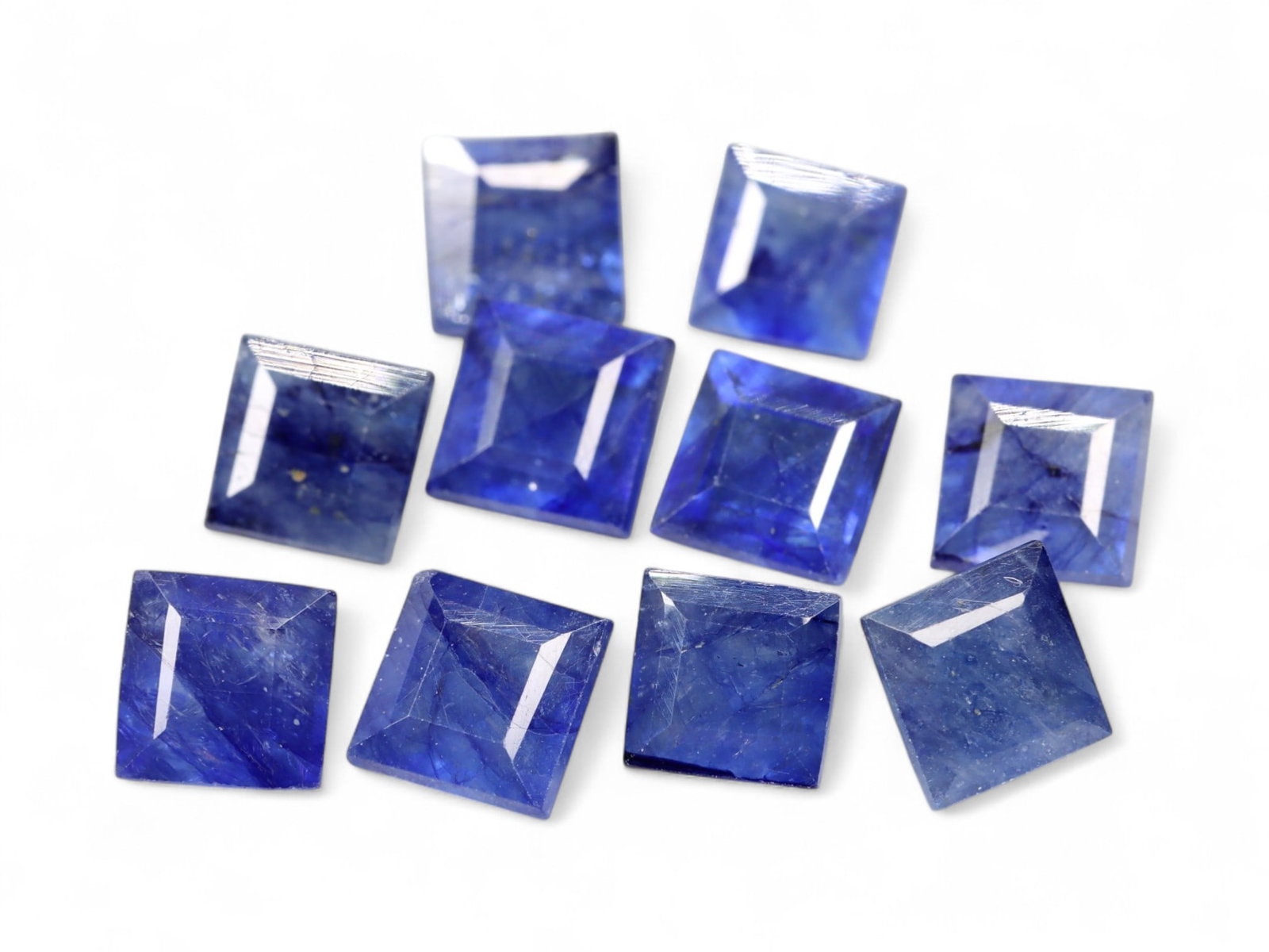 9.23 Carats Royal Blue Sapphire Square Lot - Natural African Stones: This 9.23-carat parcel of square-cut sapphires features a dynamic collection of royal to violet-blue tones with a clean, architectural shape. The step-cut faceting across each square adds depth and cr
