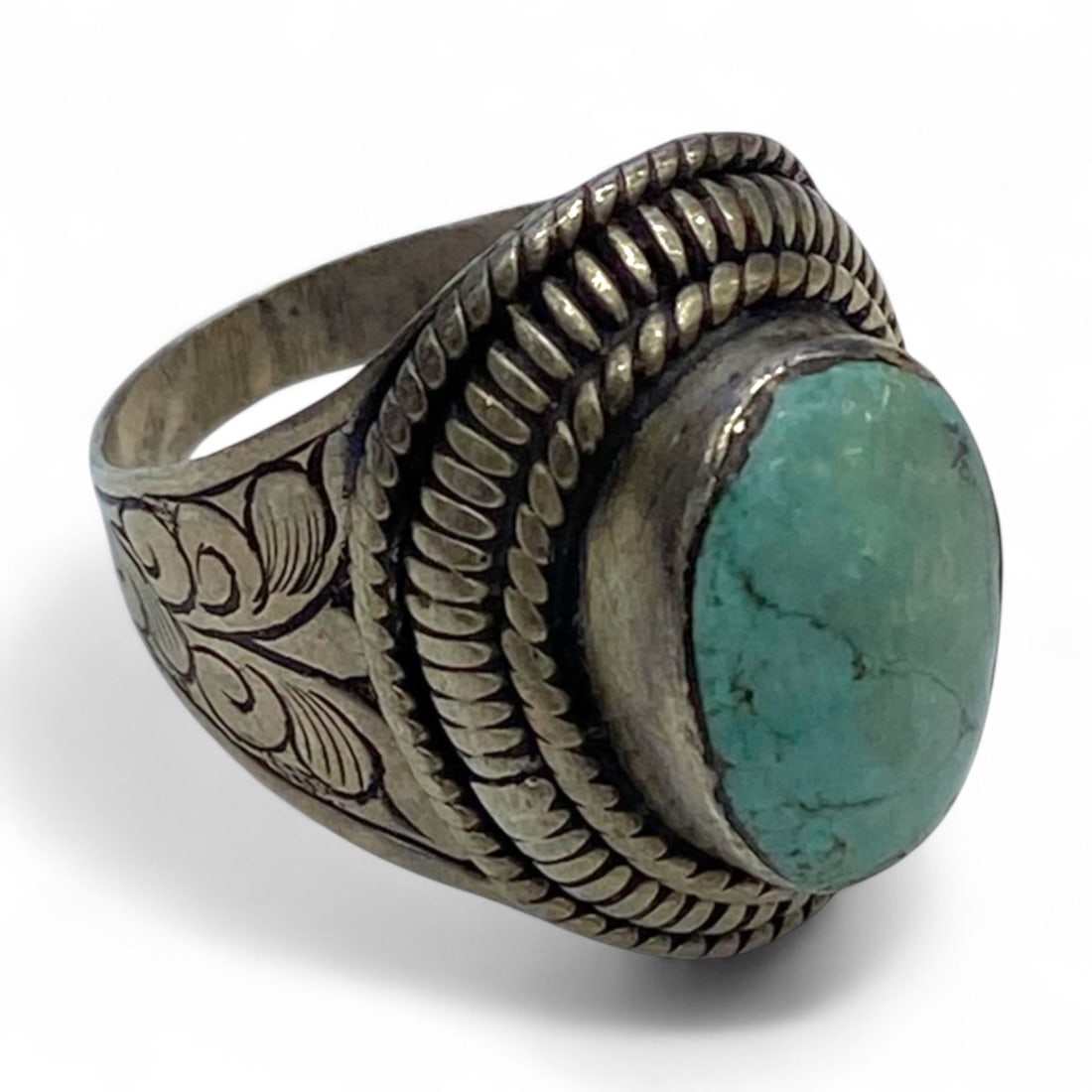 Tribal Floral Engraved Silver Ring with Oval Turquoise Cabochon, US Size 9, 10.9g: This refined tribal ring fuses elegant floral design with earthy symbolism, centering around a natural turquoise cabochon set within a bezel framed by dual twisted silver wire bands. The ring is craft