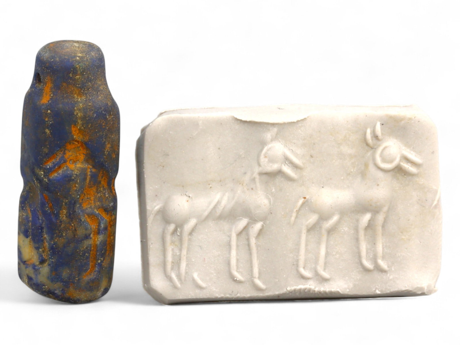 Ancient Elamite Triple Ibex Lineup Lapis Lazuli Cylinder Seal, c. 2500-1800 BCE, 7.4g: This tall and refined cylinder seal, carved from deep blue lapis lazuli, originates from the Elamite civilization and dates to approximately 2500-1800 BCE. It features a symmetrical procession of thre