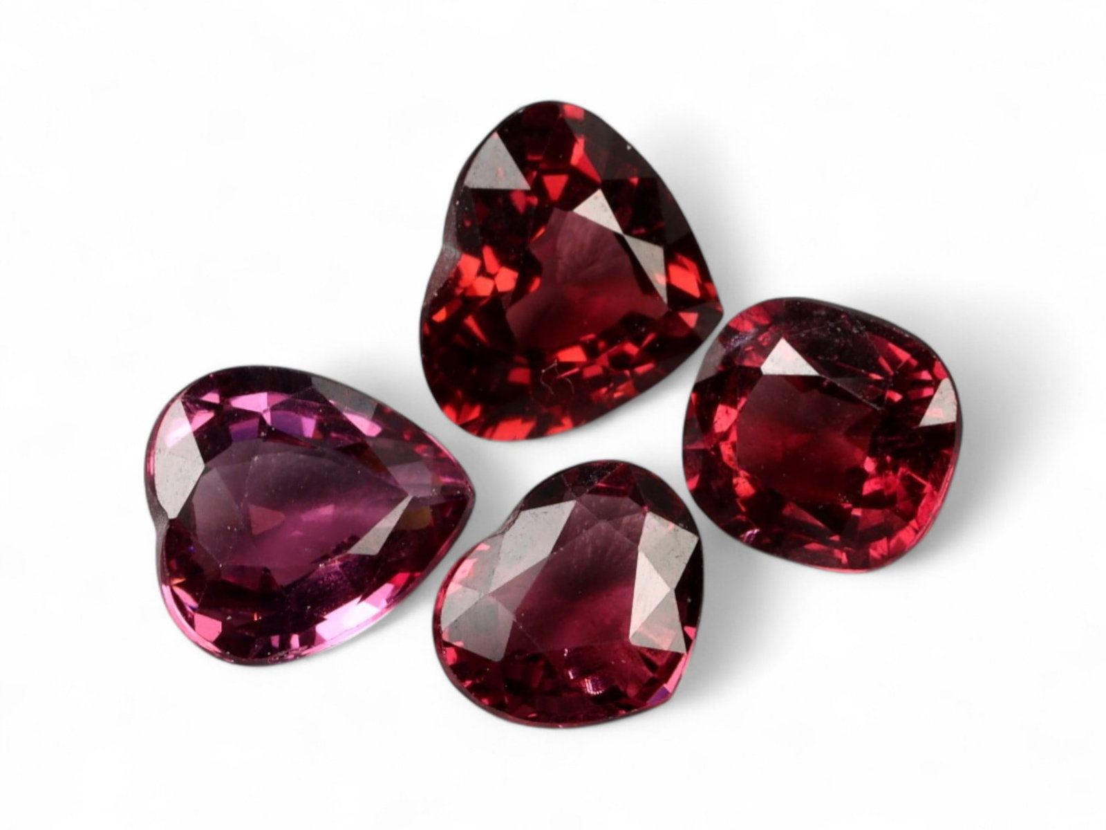 4.84 Carats Red Garnet Heart and Cushion Lot - Natural African Stones: This vibrant lot of garnets shines with rich cherry-red and wine hues, offering a romantic palette across a mix of heart and cushion cuts. Each gem boasts deep saturation with moments of pinkish fire 