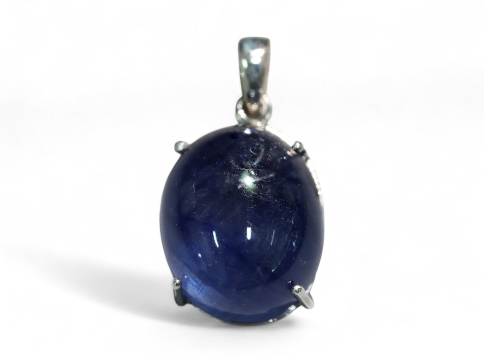 Blue Sapphire Cabochon Pendant in Sterling Silver - 3.84 Grams: This elegant pendant features a deep blue sapphire cabochon set in polished sterling silver, creating a timeless combination of regal color and classic form. The sapphire's rich, inky tone is accented