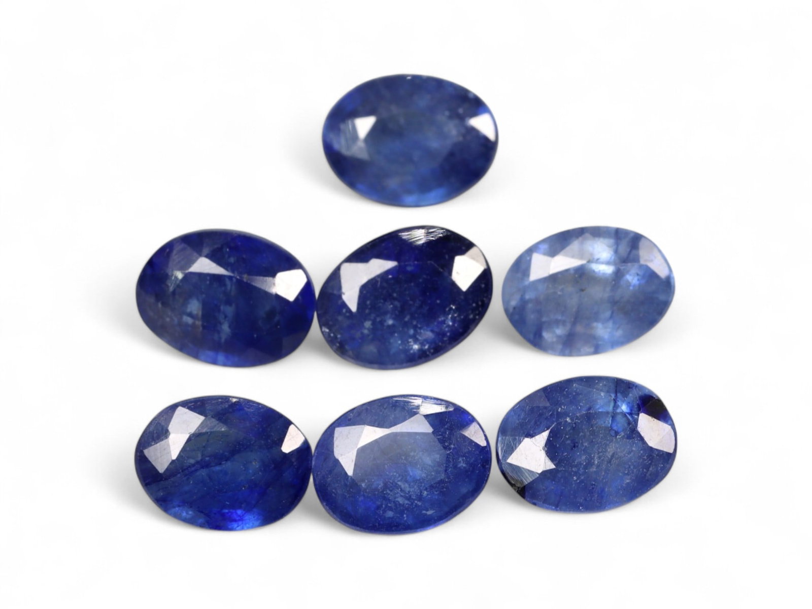 12.45 Carats Deep Blue Sapphire Lot - Natural African Stones: This richly saturated lot of deep blue sapphires evokes the elegance of twilight skies, offering velvety tones and classic appeal. Each stone has been cut in an oval faceted shape, bringing out flashe