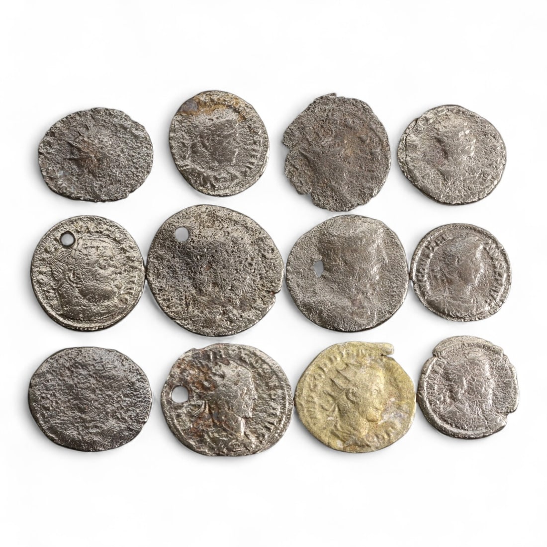 Ancient Roman Soldier-Emperor Radiate Bronze Coin Lot, c. 3rd Century CE, 32 gram: This intriguing group of 12 ancient Roman bronze coins dates to the tumultuous 3rd century CE, a period often referred to as the "Crisis of the Third Century." Spanning the reigns of numerous short-li