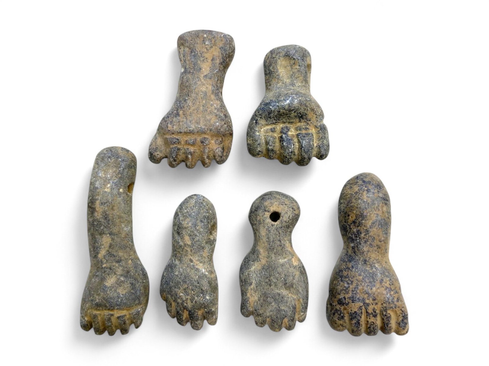 Ancient Egyptian Fist and Hand Amulet Set in Schist/Steatite, c. 2nd Millennium BCE, 60g: This evocative set of six ancient Egyptian amulets presents clenched fists and feet, carved in schist or steatite, and dating to the Middle or New Kingdom periods (c. 2000-1000 BCE). These miniature a