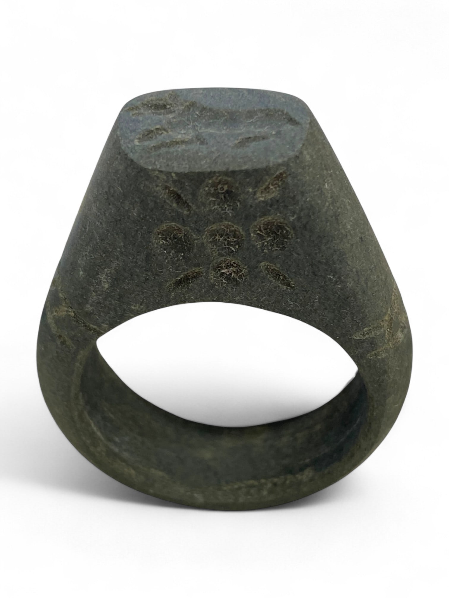 Ancient Bactrian Floral Motif Schist Signet Ring, c. 3rd-2nd Millennium BCE, 17g: This commanding ancient signet ring, carved entirely from dark schist, originates from the sophisticated Bactrian culture of Central Asia. Dated to the 3rd-2nd millennium BCE, this piece exemplifies b
