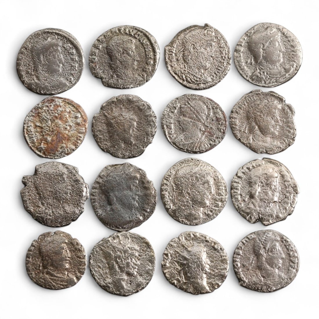 Ancient Roman Bronze Radiate & Laureate AE3 Coin Hoard, c. 3rd-4th Century CE, 30 gram: This compelling group of 16 ancient Roman bronze coins spans a transitional era from the late 3rd to early 4th century CE, when Rome's emperors balanced old traditions with emerging religious and mili