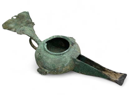 Ancient Roman Ornamental Bronze Oil Lamp with Flared Handle, c. 1st-3rd Century CE, 322g: This elegant ancient Roman bronze oil lamp, weighing 322 grams and measuring 15 cm in length by 12 cm across, showcases the refined artistry and functional sophistication of Roman domestic life. With