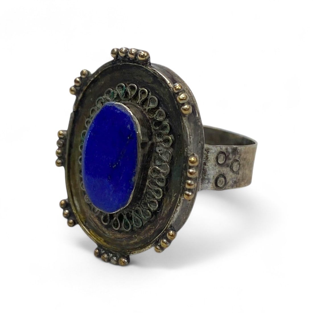 Antique Central Asian Lapis Filigree Beaded Silver Ring, c. Early 20th Century, 5g, US 7: This striking oval-faced ring, handcrafted in Central Asia during the early 20th century, embodies the region's elaborate jewelry traditions rooted in Silk Road aesthetics. At its center lies a vivid 