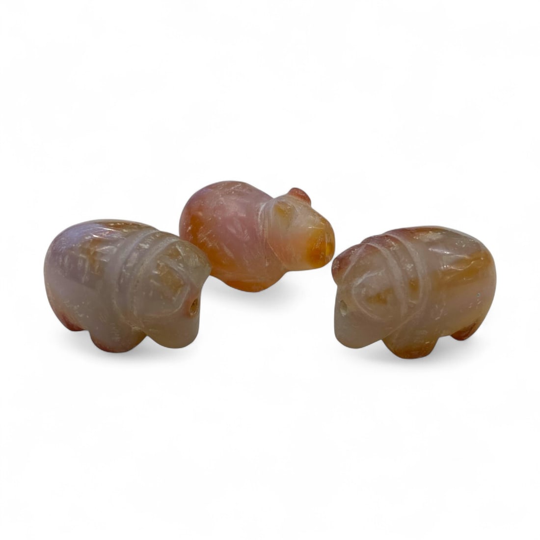 Ancient Himalayan Bear Amulet Trio in Carnelian, Symbolic Protective Beads, 1st Millennium BCE, 3cm: This captivating trio of ancient Himalayan amulets, carved from translucent carnelian, embodies the spiritual essence and artistic charm of early Himalayan cultures. Each figure, roughly 3 cm in lengt