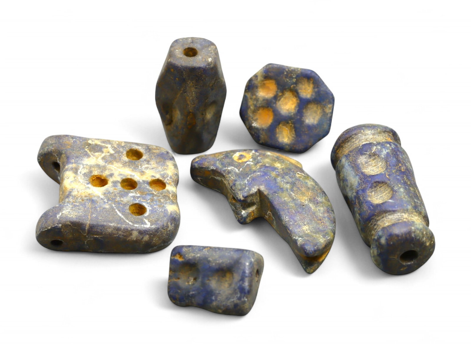 Ancient Phoenician Lapis Lazuli Amulet and Bead Ensemble with Fish Talisman, 8th-6th Century BCE 26g: This eclectic and symbolically rich group of six Phoenician amulets and beads, carved from intensely veined lapis lazuli, dates to the Iron Age, circa 8th to 6th century BCE. Measuring between 1.4 and