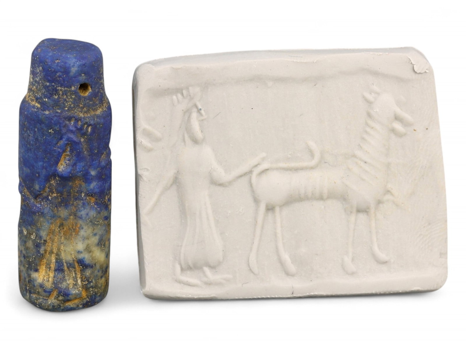 Ancient Akkadian Worshipper and Sacred Animal Motif Lapis Lazuli Cylinder Seal, c. 2350-2150 BCE, 9g: This commanding lapis lazuli cylinder seal, dating to the Akkadian Empire (c. 2350-2150 BCE), features a deeply spiritual scene depicting a robed figure-likely a priest, devotee, or ruler-standing rev