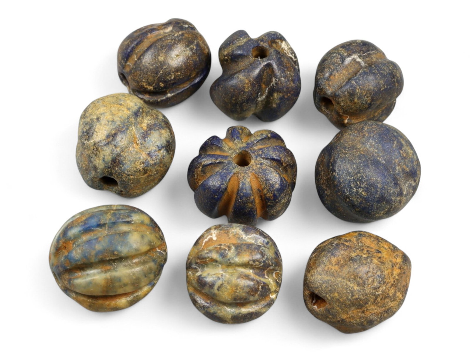 Ancient Egyptian Melon-Form Lapis Lazuli Beads Collection, c. 18th-12th Century BCE, 31g: This rare group of ancient Egyptian beads, carved from richly mottled lapis lazuli, dates to the New Kingdom period (c. 18th-12th century BCE), a time of extraordinary cultural and artistic achievemen