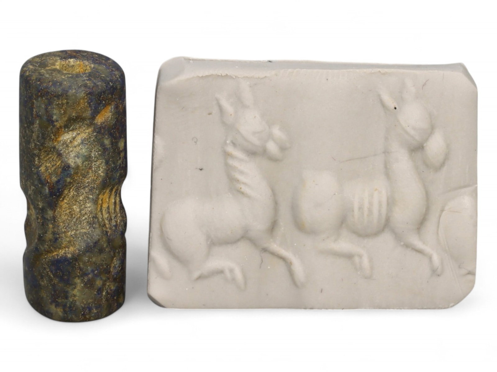 Ancient Akkadian Leaping Gazelles Trio Lapis Lazuli Cylinder Seal, c. 2350-2150 BCE, 4.8g: This captivating Akkadian cylinder seal, carved from deep blue lapis lazuli and weighing 4.8 grams (0.17 oz), offers a vivid portrayal of three elegant gazelles in dynamic motion. Measuring 2.3 cm (0.