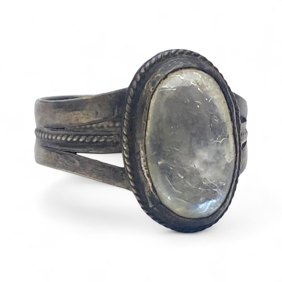 Antique Early-Mid 20th Century Silver Ring with Rock Crystal Cabochon, 4g: This delicate antique silver ring features an oval rock crystal cabochon, its soft translucence revealing subtle internal inclusions that enhance its natural character. The stone is set within a fine 