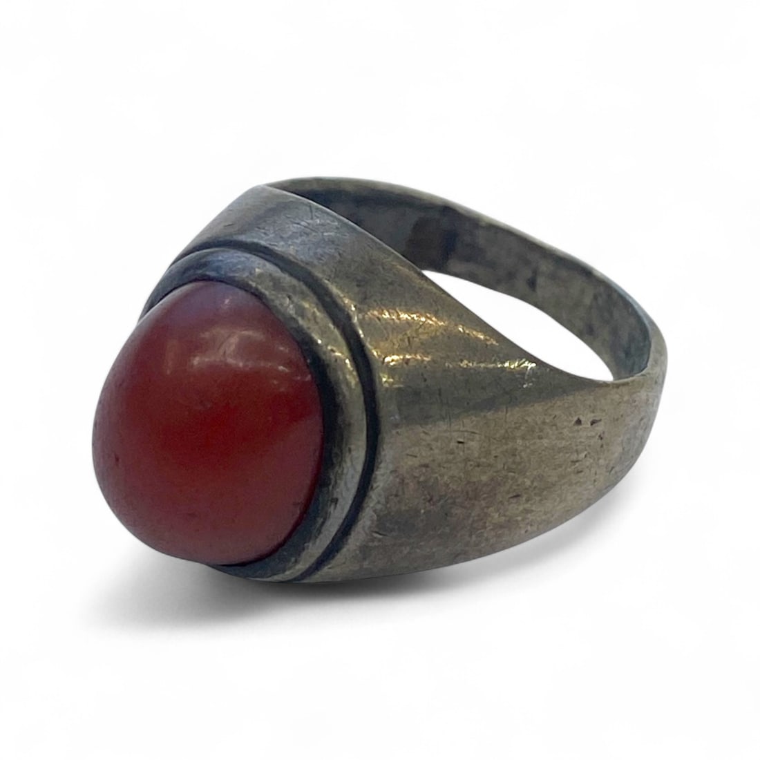 Antique Mid-20th Century Silver Ring with Minimalist Red Carnelian Cabochon, 6g: This understated antique silver ring features a smooth, round red carnelian cabochon, set within a clean and minimal bezel. The unadorned shoulders taper gracefully into a narrow band, allowing the st