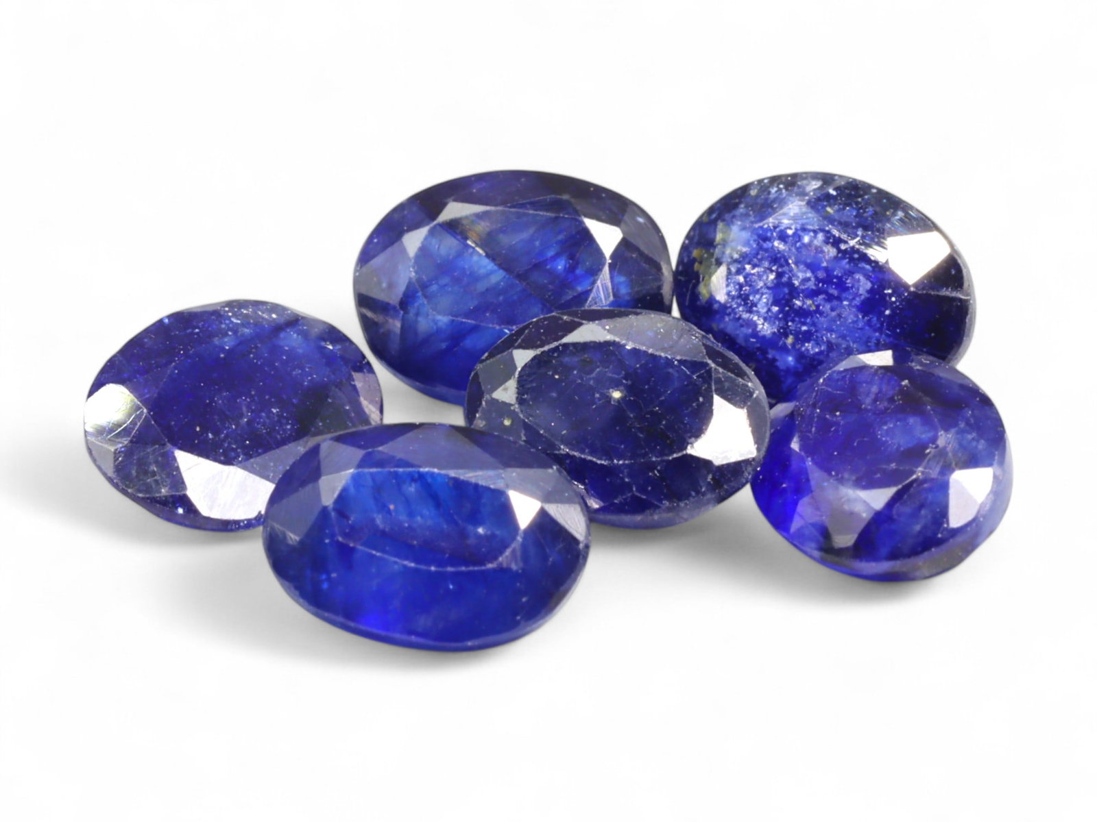 11.69 Carats Royal Blue Sapphire Parcel - Natural Sri Lankan Stones: This captivating parcel of sapphires glows in a spectrum of royal to violet-blue tones, each stone showcasing the deep, velvety richness characteristic of natural blue sapphire. The oval cuts enhance 
