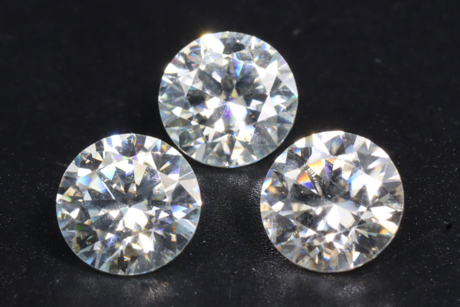 3.57 Carats Brilliant White Moissanite Trio - Precision Cut Loose Stones: This sparkling trio of round brilliant-cut moissanite stones offers a dazzling display of fire and brilliance, closely emulating the optical allure of fine diamonds. With exceptional faceting and high