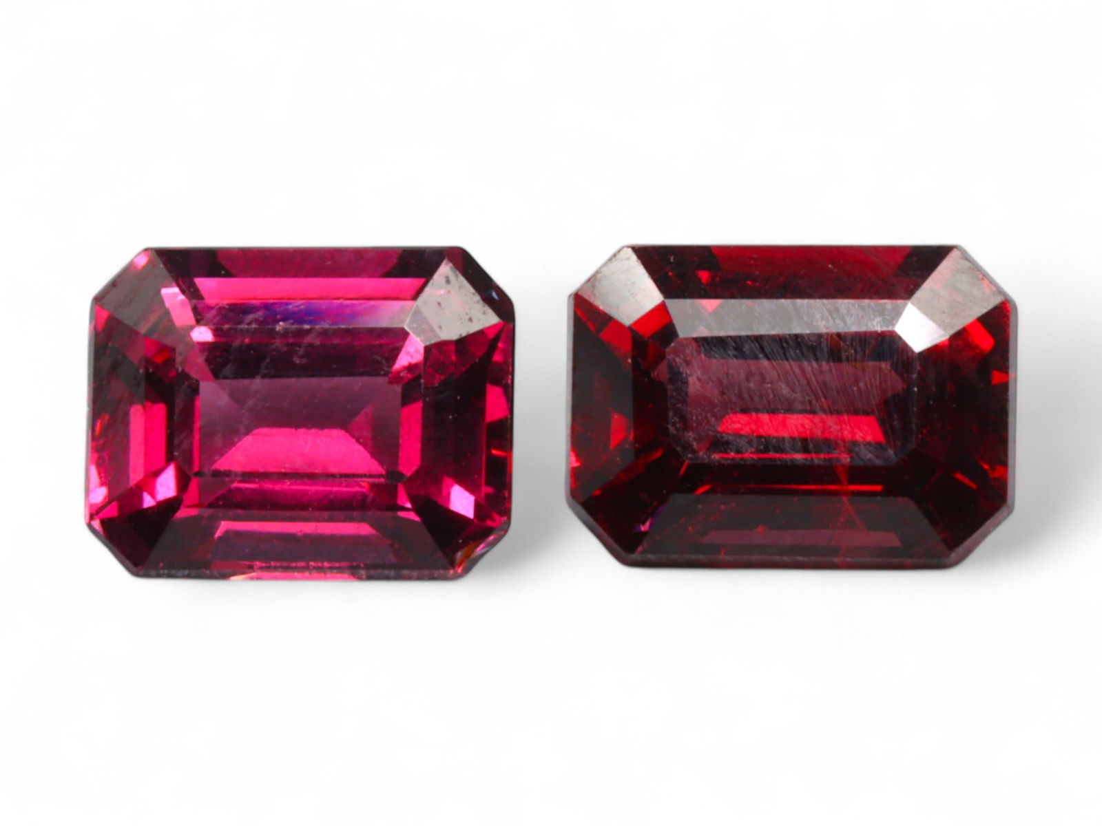 4.36 Carats Deep Red Garnet Emerald-Cut Pair - Natural Mozambique Stones: This elegant garnet pair features richly saturated deep red hues, elevated by precision emerald cuts that bring out their internal fire. Each stone exhibits strong linear symmetry, with sharp corners