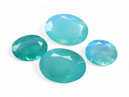 8.27 Carats Aqua Blue Welo Opal Lot - Faceted and Color Enhanced Ethiopian Stones: This luminous set of faceted Welo opals showcases a refreshing aqua-to-teal color palette, achieved through expert enhancement. Their translucent bodies shimmer with subtle hints of mint, seafoam, and