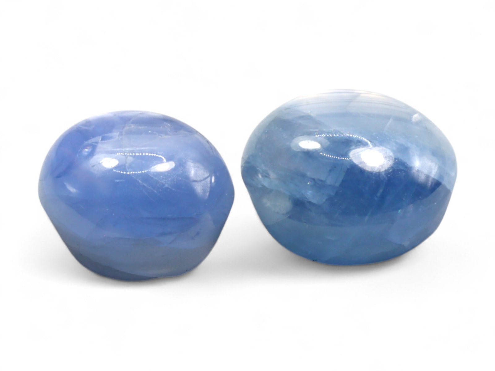 6.19 Carats Light Blue Star Sapphire Pair - Natural Burmese Stones: This gentle star sapphire duo glows with soft pastel blue hues and silken translucency, embodying the tranquil elegance of traditional Burmese material. Cut in rounded cabochon form, both stones revea