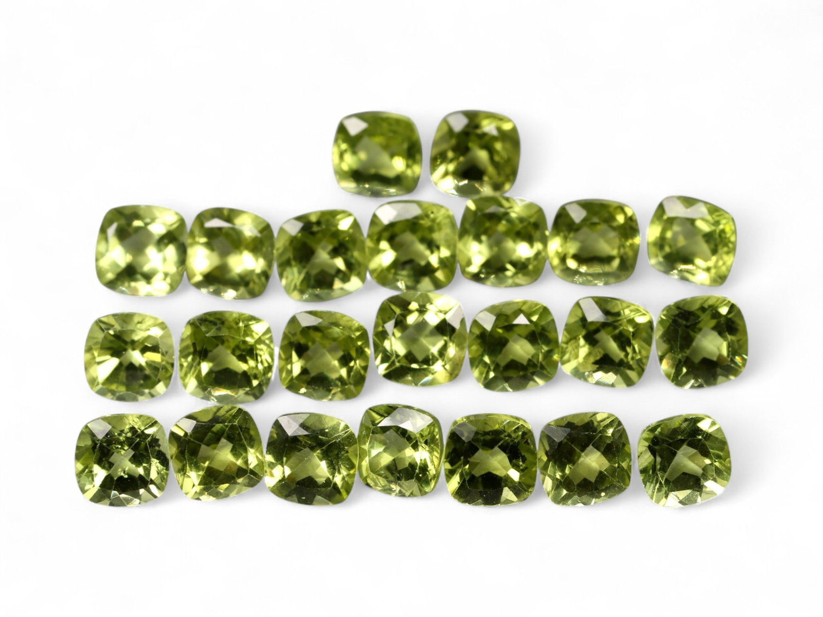 15.62 Carats Bright Green Peridot Parcel - Natural Cushion-Cut Stones: This well-matched parcel of cushion-cut peridot gems dazzles with a crisp, chartreuse-green brilliance. Each stone is precisely faceted to maximize light return, creating a vibrant play of reflections