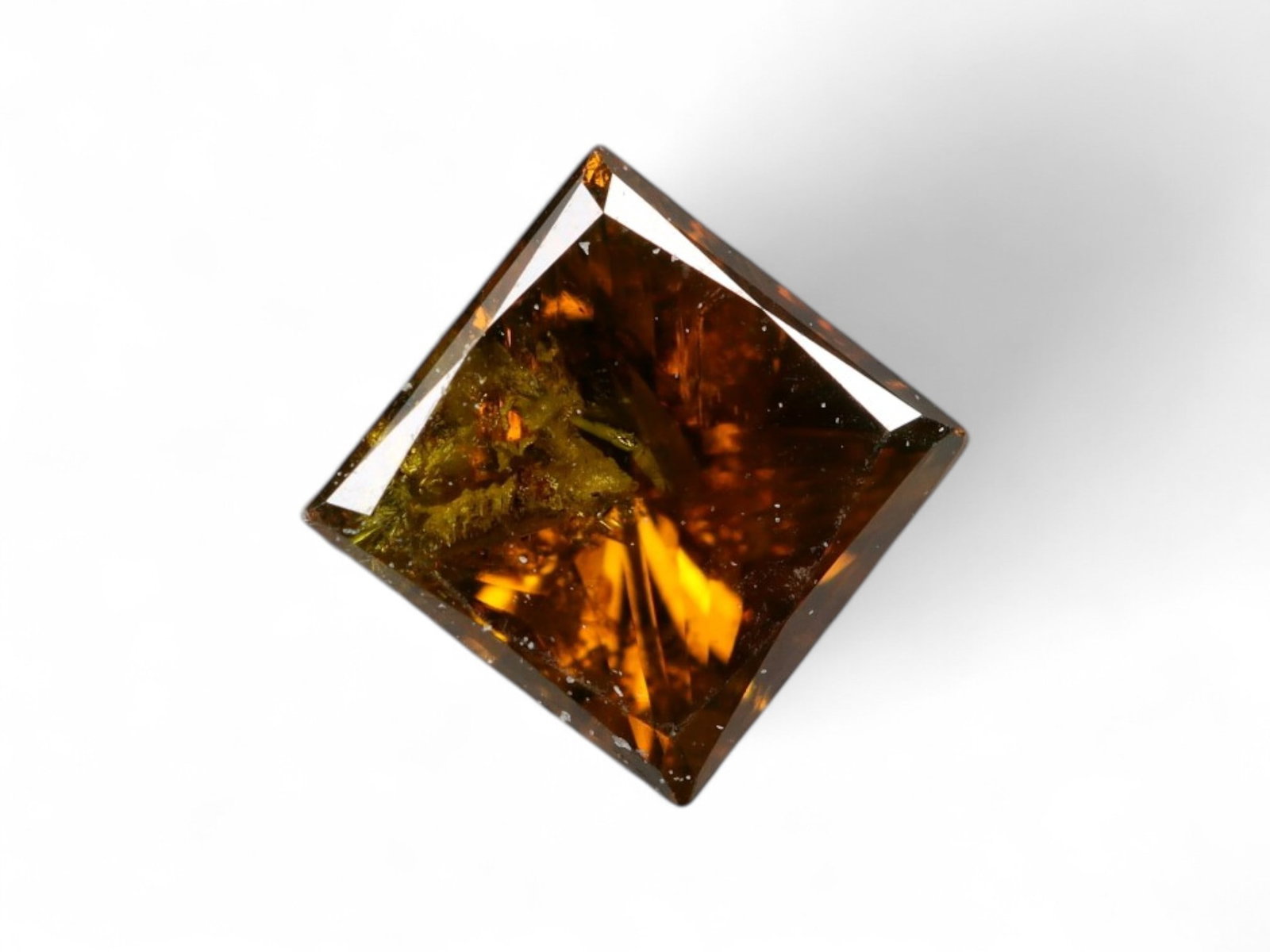 0.47 Carats Golden Brown Diamond Princess Cut - Natural Stone: This diamond radiates a warm golden-brown hue, brought to life by the crisp geometry of its princess cut. The symmetrical square shape, paired with precise faceting, creates a captivating interplay of