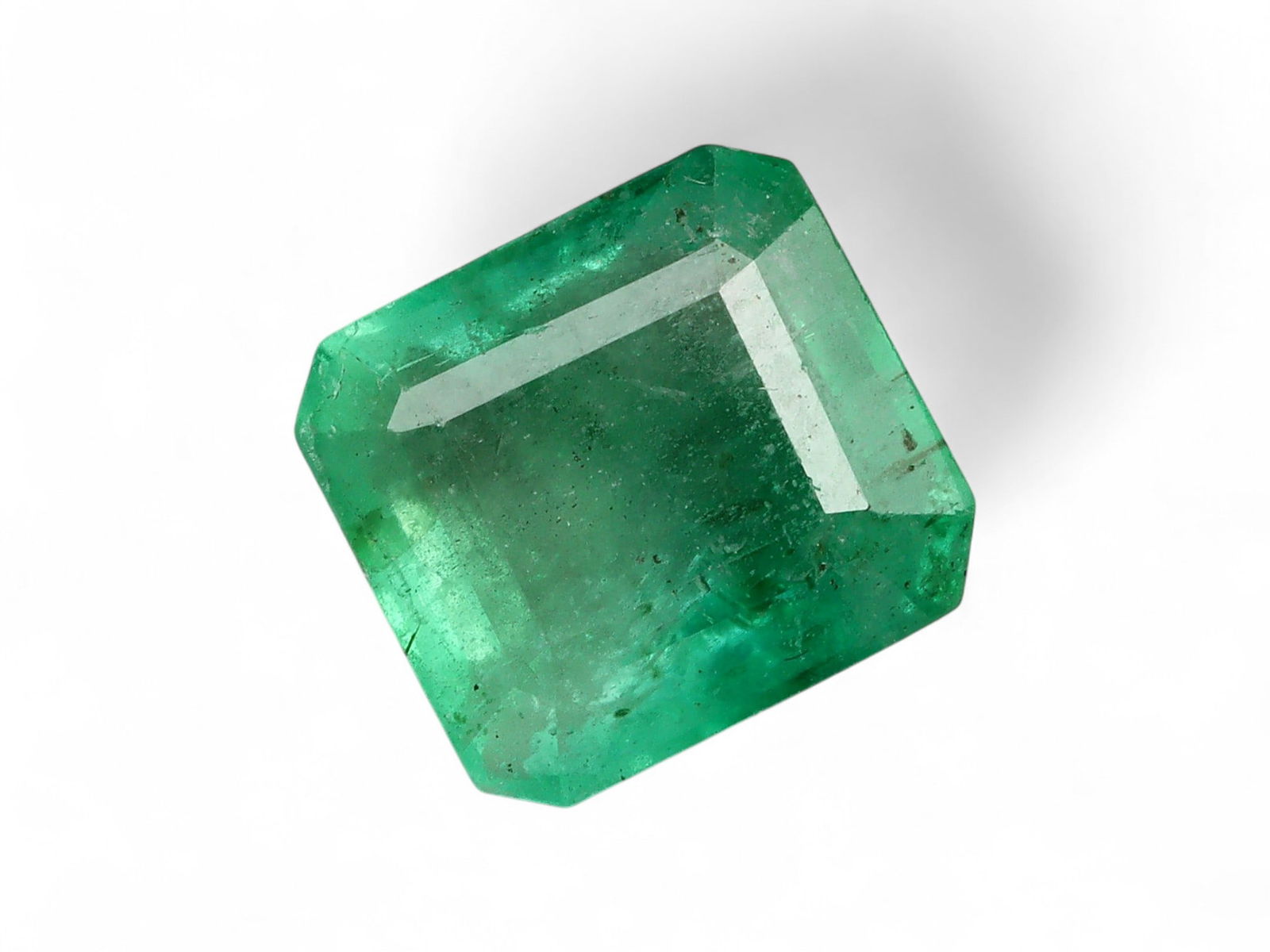 1.76 Carats Vivid Green Emerald - Natural Zambian Stone: This striking emerald displays a lively and saturated green, characteristic of Zambia's most coveted production. The stone's vivid hue is complemented by a fine balance of transparency and natural inc