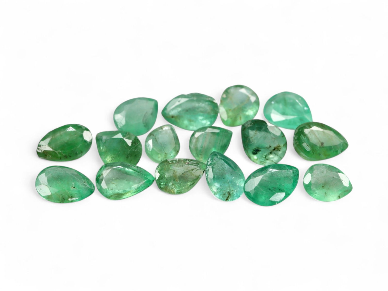 4.05 Carats Vivid Green Pear-Cut Emerald Selection - Natural Zambian Stones: This captivating selection of pear-cut emeralds presents a lively spectrum of fresh green tones, from deep, saturated forest hues to lighter spring greens with natural internal textures. The cuts are