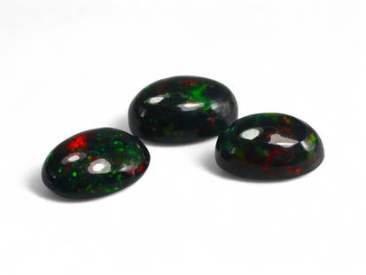 4.56 Carats Black Smoked Welo Opal Cabochon Lot - Natural Ethiopian Stones: This striking trio of black smoked Welo opals exhibits an intense play-of-color, with flashes of fiery red, neon green, and golden orange dancing vividly against their deep, smoky base. The cabochon c