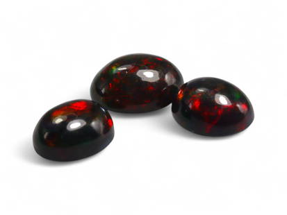 4.69 Carats Black Smoked Welo Opal Cabochon Lot - Natural Ethiopian Stones: This striking trio of black smoked Welo opals exhibits an intense play-of-color, with flashes of fiery red, neon green, and golden orange dancing vividly against their deep, smoky base. The cabochon c