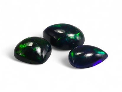 4.18 Carats Black Smoked Welo Opal Cabochon Lot - Natural Ethiopian Stones: This striking trio of black smoked Welo opals exhibits an intense play-of-color, with flashes of fiery red, neon green, and golden orange dancing vividly against their deep, smoky base. The cabochon c