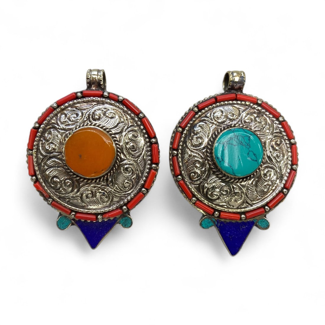 Vintage Himalayan Tribal Coral Turquoise Amber Lapis Silver Pendant Pair, mid-20th Century, 100g: This striking pair of vintage Himalayan pendants, likely from Nepal and dating to the mid-20th century, showcases the ornate silverwork and vibrant stone inlay characteristic of the region's tradition